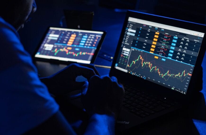 Analyst reviewing financial charts across multiple screens