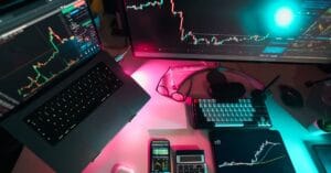 Modern trading workstation with multiple market charts on digital screens
