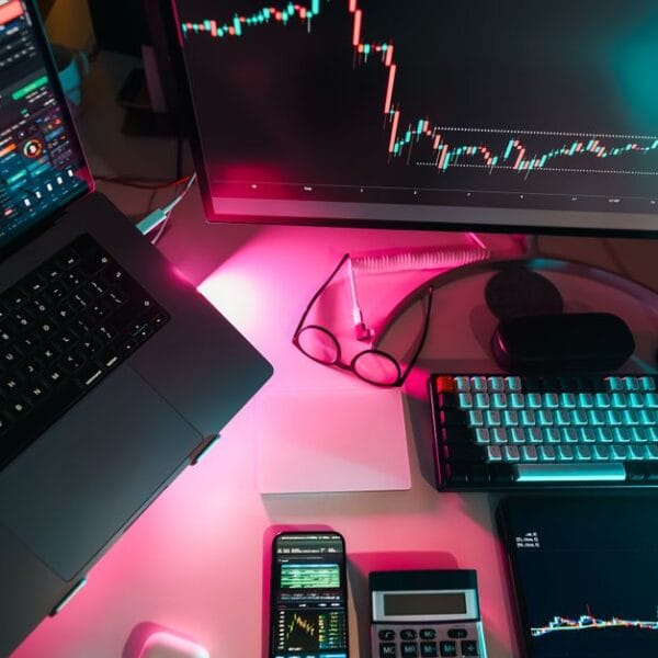 Modern trading workstation with multiple market charts on digital screens