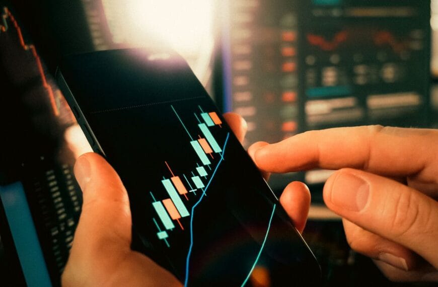 Hands reviewing financial market charts on a smartphone