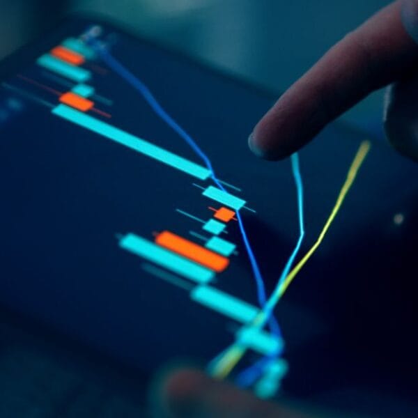 Finger inspecting financial data on a tablet chart