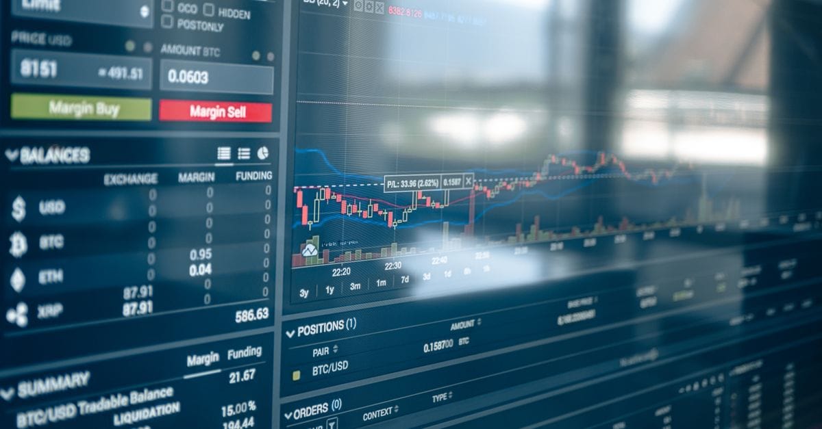 Financial market screens showing exchange prices and charts