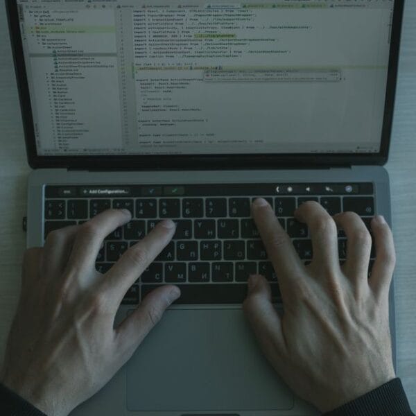 Developer working with code on a laptop