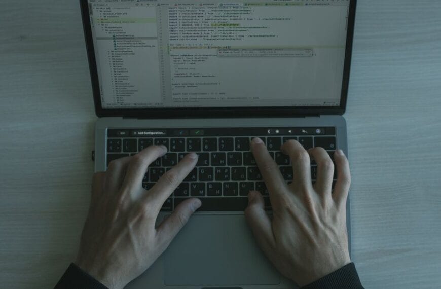 Developer working with code on a laptop