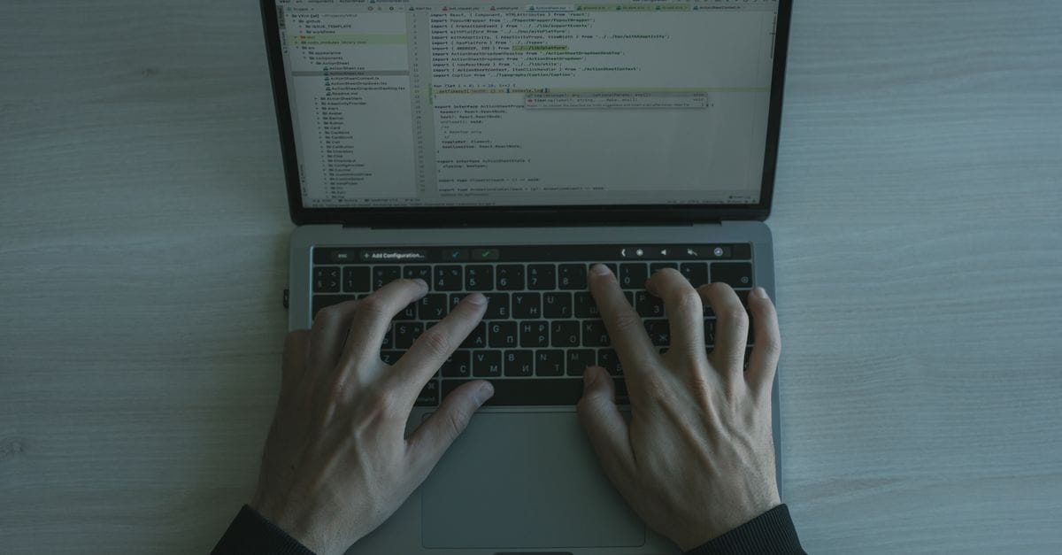 Developer working with code on a laptop