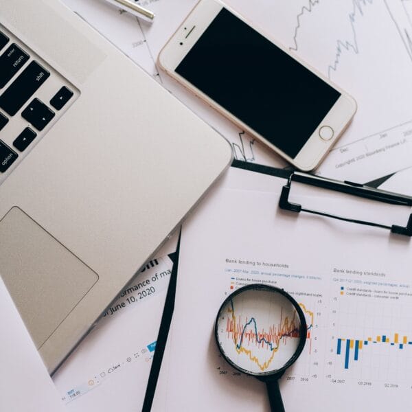 Financial records, smartphone and magnifying glass used to examine what portfolio trackers know and miss
