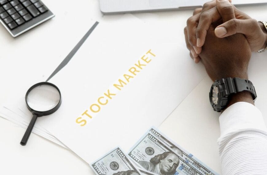 Hands reviewing financial market documents with calculator, cash and magnifying glass for crypto risk assessment