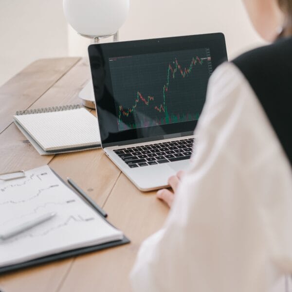 Researcher reviewing financial charts on a laptop while investigating a crypto asset