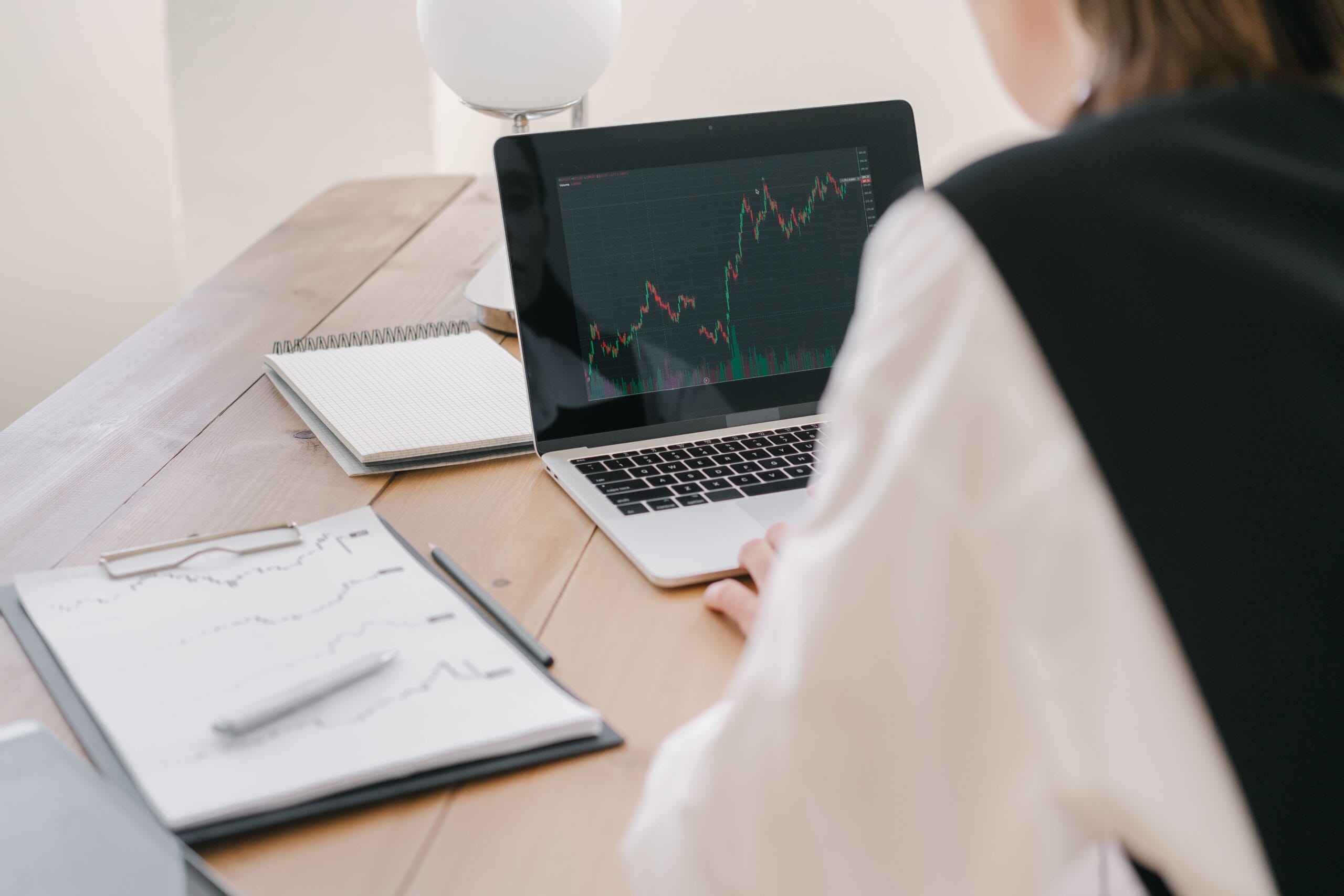 Researcher reviewing financial charts on a laptop while investigating a crypto asset
