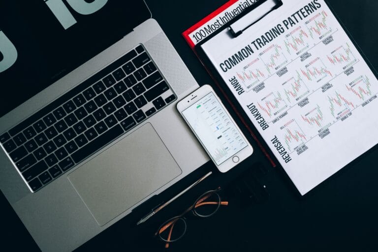 Laptop, smartphone and printed financial records representing wallet addresses, exchange APIs and CSV evidence sources