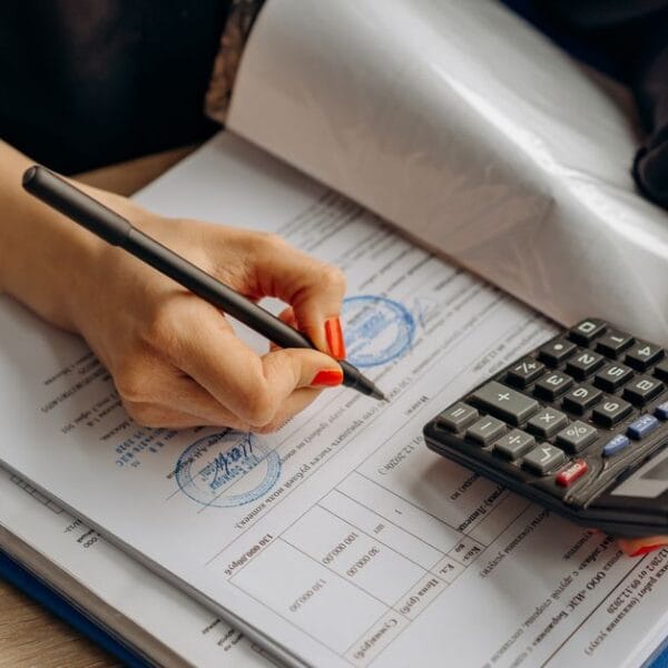 Accountant reviewing financial documents with a calculator