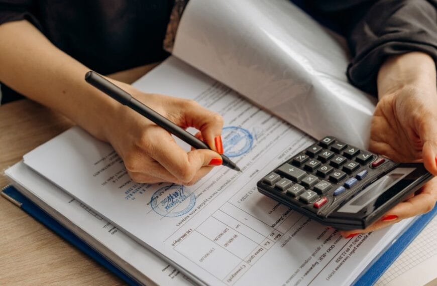 Accountant reviewing financial documents with a calculator