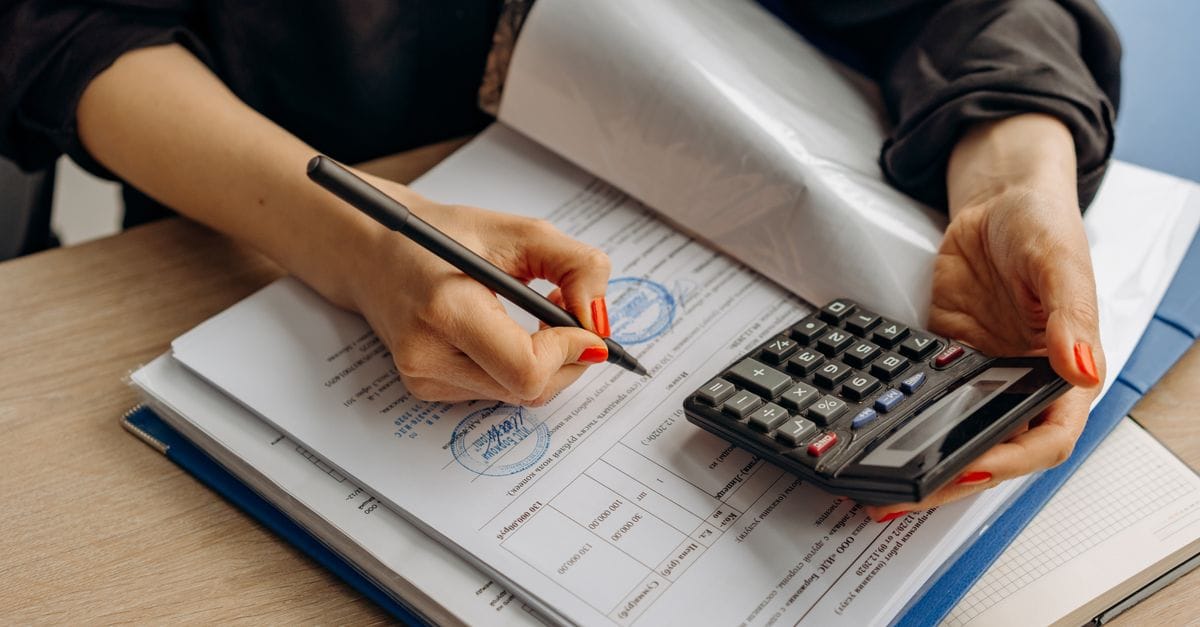 Accountant reviewing financial documents with a calculator