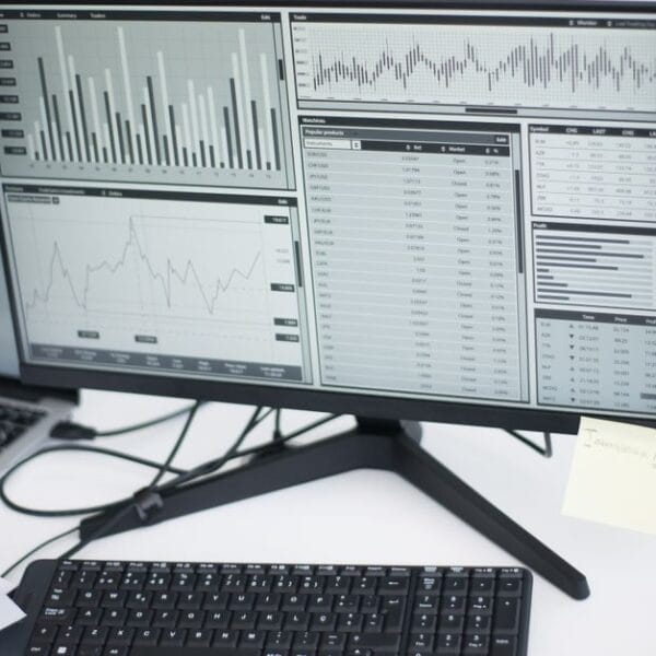 Multiple computers displaying analytical graphs in a research workspace