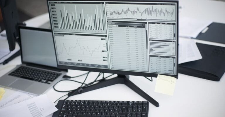 Multiple computers displaying analytical graphs in a research workspace
