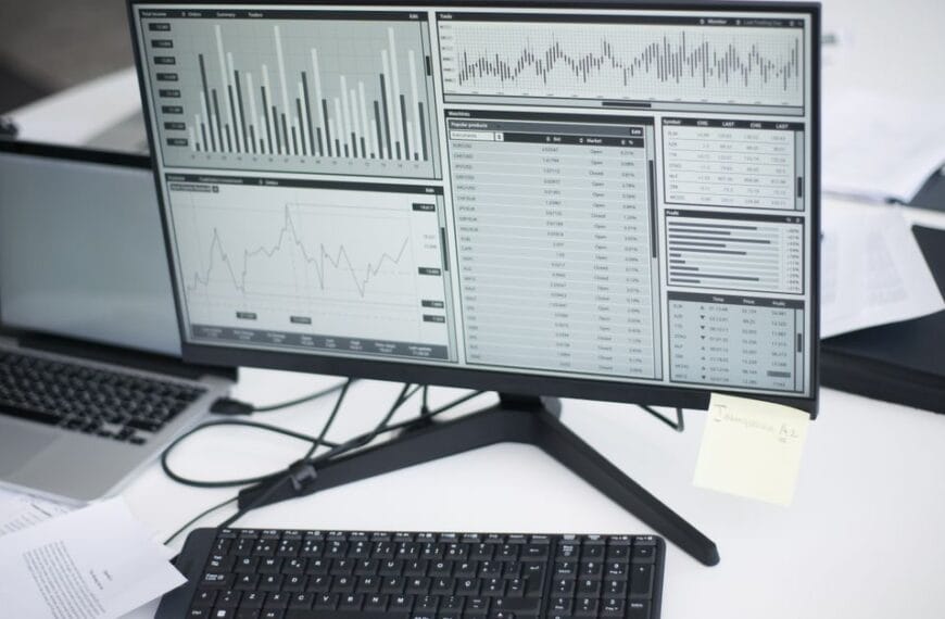Multiple computers displaying analytical graphs in a research workspace